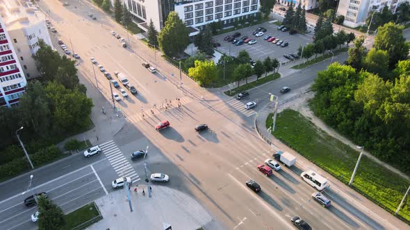 City traffic street crossroad in the rays of the setting sun. Drone footage alt