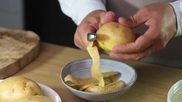 Peeling potatoes with a vegetable peeler