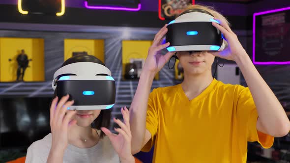 Teenage Friends a Boy and a Girl Wear Virtual Reality Glasses alt