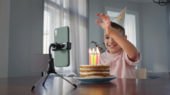 Boy Sitting In Front Of Cake At The Table alt