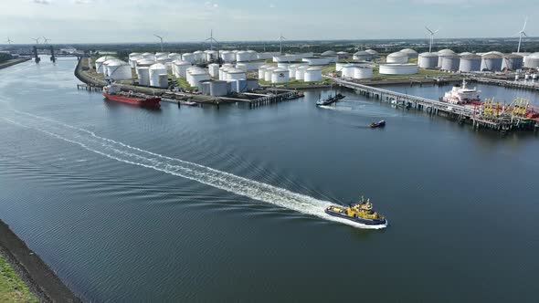 Tug Boat in Port Working to Assist with Ship Manoeuvres alt