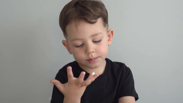 the Little Boy Licks His Fingers