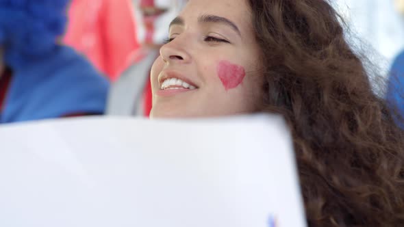Loyal Caucasian Female Fan Cheering with Poster at Stadium alt