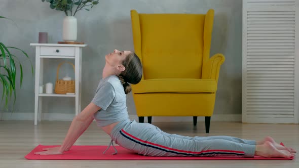Brunette female does yoga exercises for stretching the back muscles in the alt