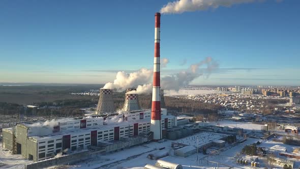 Upper View Modern Heating Plant with Heavy Steam on Winter Day alt