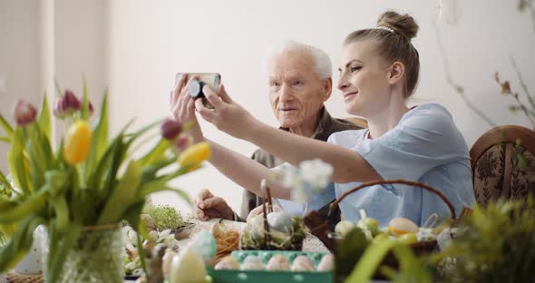 Senior Man and Woman Taking Selfie Photo at Easter Holidays. alt