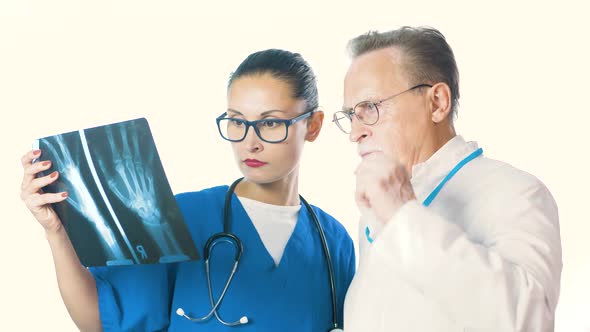 Portrait Of A Serious Doctor And A Beautiful Nurse Holding X-Ray