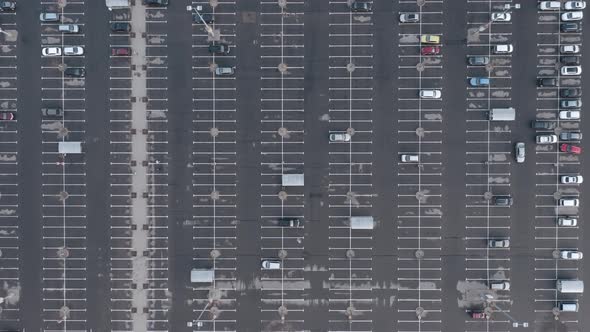 AERIAL: Very High Flight Over Almost Empty Parking Space Lot 