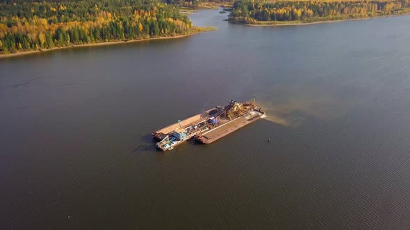 Floating Barge Extracting Sand and Gravel From River Bottom