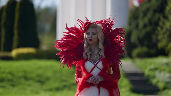 Blonde Woman in Fantasy Red Dress is Walking in Garden Red Queen Medieval Dame alt
