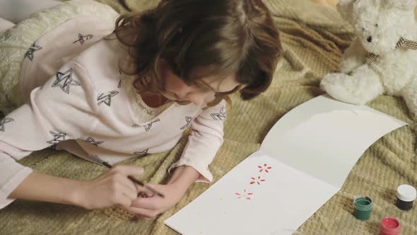 Little Girl Drawing Colorful Flowers in Her Album, Dreaming of Summer and Warmth alt