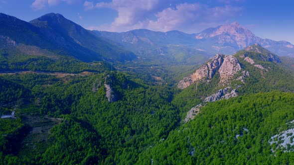 Aerial View of Mountain Peaks Covered with Beautiful Green Forests alt