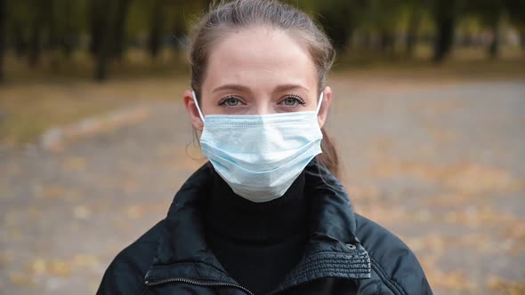 Portrait of a Young Woman Wearing Protective Mask on Street