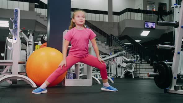 Fit Athletic Baby Girl Work Out Stretching Doing Her Fitness Exercise alt