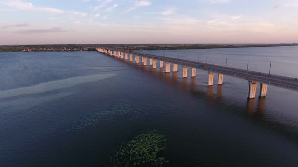 Aerial Shot of a Far-off Bridge Over the Dnipro From a Drone Flying Along in Summer