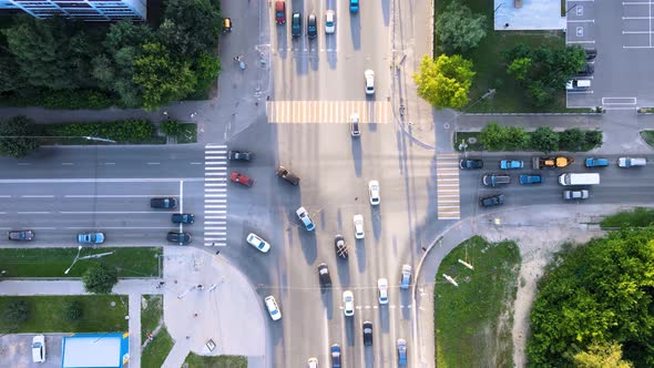 City traffic street crossroad in the rays of the setting sun. Drone footage alt