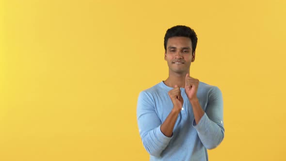 Half body of happy Indian man dancing  isolated on yellow background