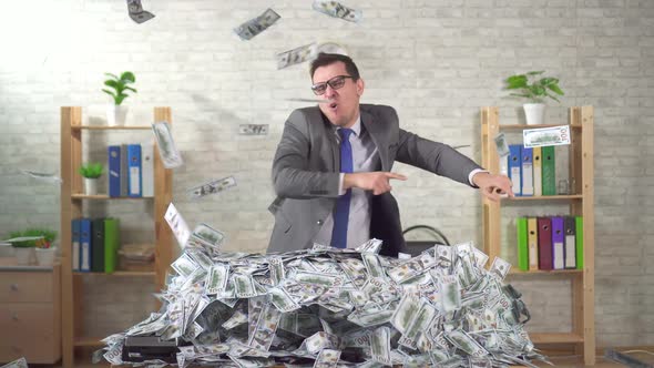 Happy Man Successful Businessman Rejoices in a Pile of Banknotes alt
