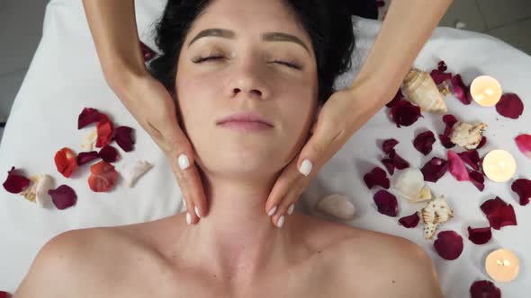 Female Massages Womans's Neck and Chin at Spa