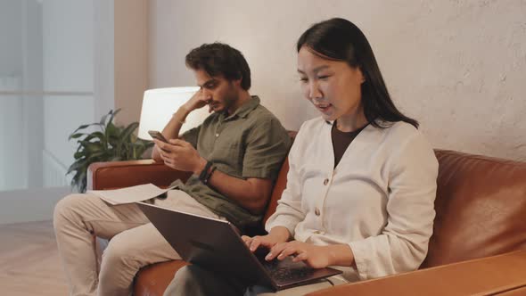 Couple Working on Couch alt