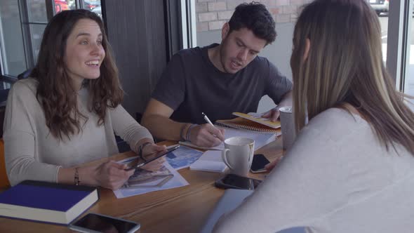 Group of young business people working together in casual workspace