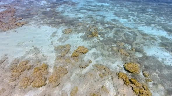 White Sandy Coral Reef in the Clear Turquoise Light Blue Sea of the Tropical Coastline alt