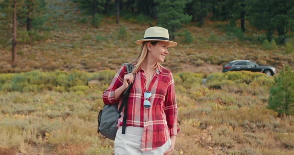 Smiling Traveler Woman on Early Autumn Nature Background. Smiling Hiker, Nature alt