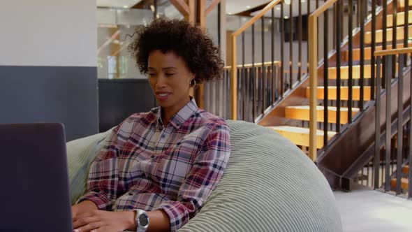 Businesswoman making video call on laptop in a modern office 4k alt