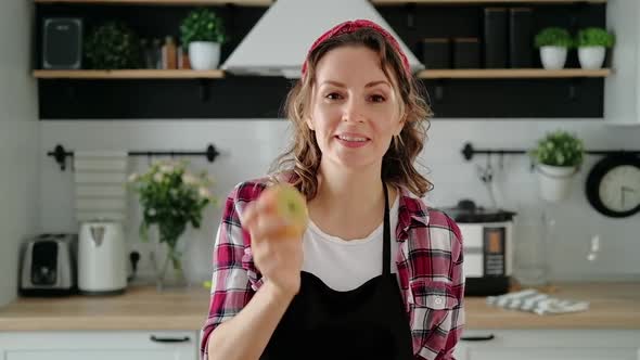 Young woman leads a culinary blog. Pretty housewife runs vlog in home kitchen.