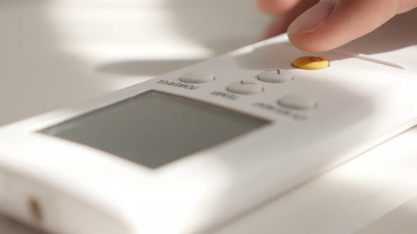 Power button pushing on air conditioner remote control 4K 2160p UltraHD footage - Power button press alt