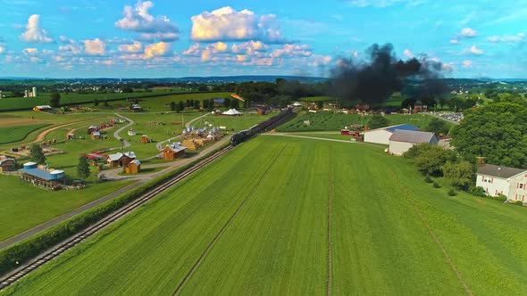 Aerial View of Amish Farm lands With a Single Rail Road Track and a Steam Passenger Train alt