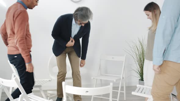 Happy Men and Women Coming to Support Group Meeting Talking Sitting in Circle alt