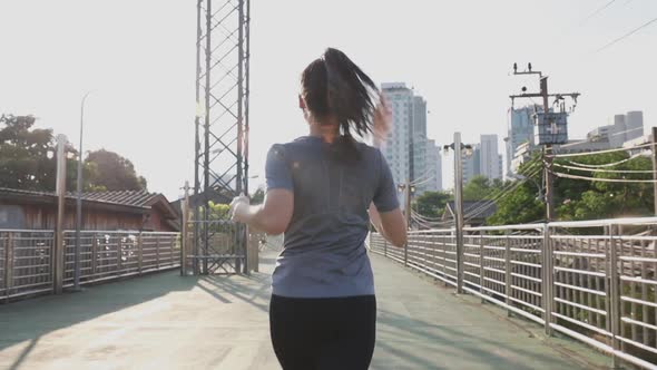 Athlete young Asian woman stretching before running on the street in the city.