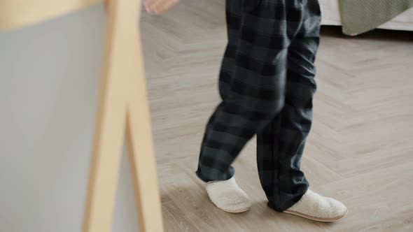 Tilt-up of Creative Young Man Dancing Listening To Music in Front of Mirror in Bedroom alt