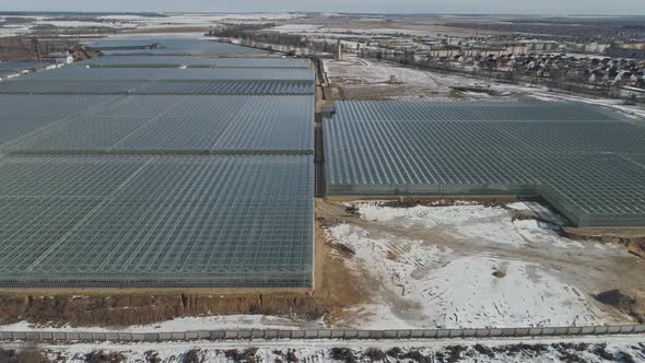 Flying Over Glass Greenhouses Growing Plants View From a Height Reflections in Glass Surfaces alt