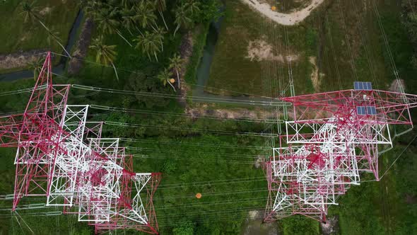 Red and white metal electric transmission tower.  alt