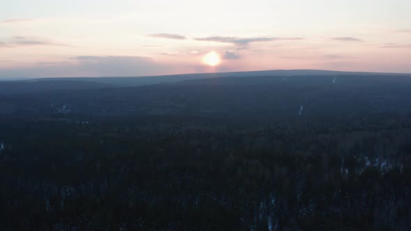 Aerial View of the Sunset Over the Endless Forest alt