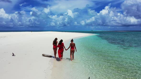 Ladies sunbathing on perfect sea view beach break by turquoise water and white sandy background of t alt