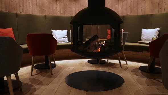 Cosy Fireplace in a Mountain Chalet's Warm Wooden Interior in a Luxury Hotel alt