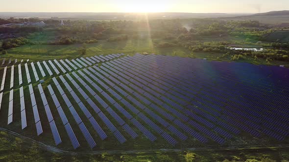 Ecology solar power station panels in the fields green energy at sunset alt