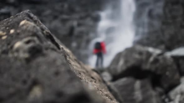 Hiker Standing On Rocks Under Fossa Waterfall alt