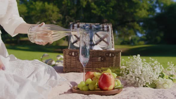 Slow Motion Lady in White Boho Dress Pouring Bubbly Champagne in Glass Flute 6K alt