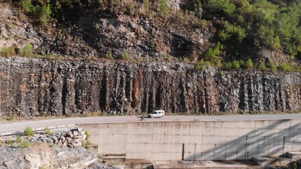 Professional cyclist climbing uphill on road bike. Cycling in mountains alt