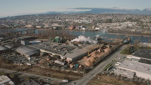 Aerial flying over a wood processing facility in Greater Vancouver. alt