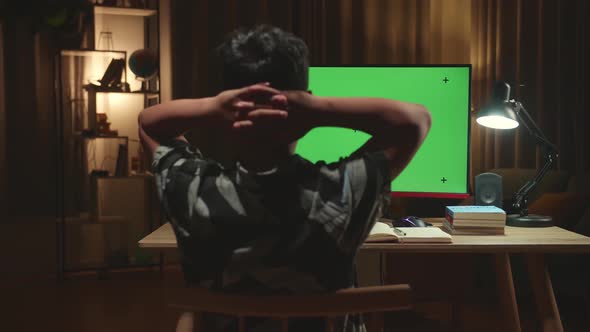 Teenage Boy Headache While Distance Learning With Mock Up Computer Green Screen From Home alt