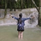 Woman Standing In The River With Her Raised Hands To Waterfall - VideoHive Item for Sale