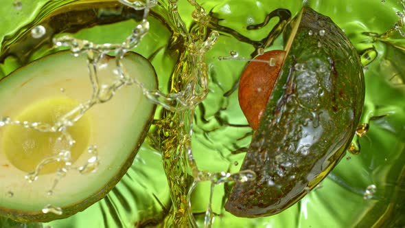 Super Slow Motion Shot of Fresh Avocado Falling and Splashing Into Oil at 1000 Fps alt