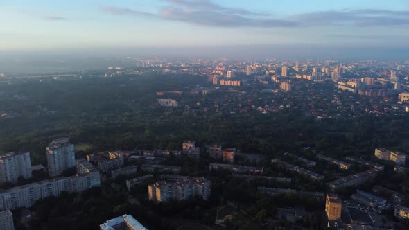 Aerial sunrise in city with epic clouds, sun shine