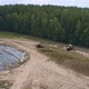 Aerial view of tractors tamp the silage in the Silo Trench next to the forest 11 - VideoHive Item for Sale