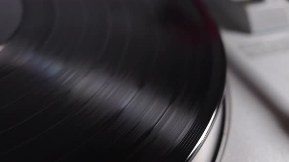 Vinyl Record Is Spinning On A Turntable With Arm And Needle alt